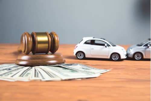 Concept of Marietta car accident lawyer toy cars money and judge gavel