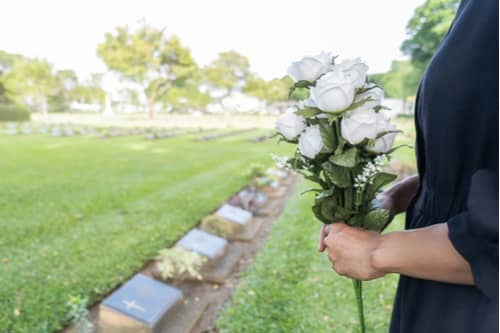 Smyrna wrongful death lawyer concept woman holding roses at grave